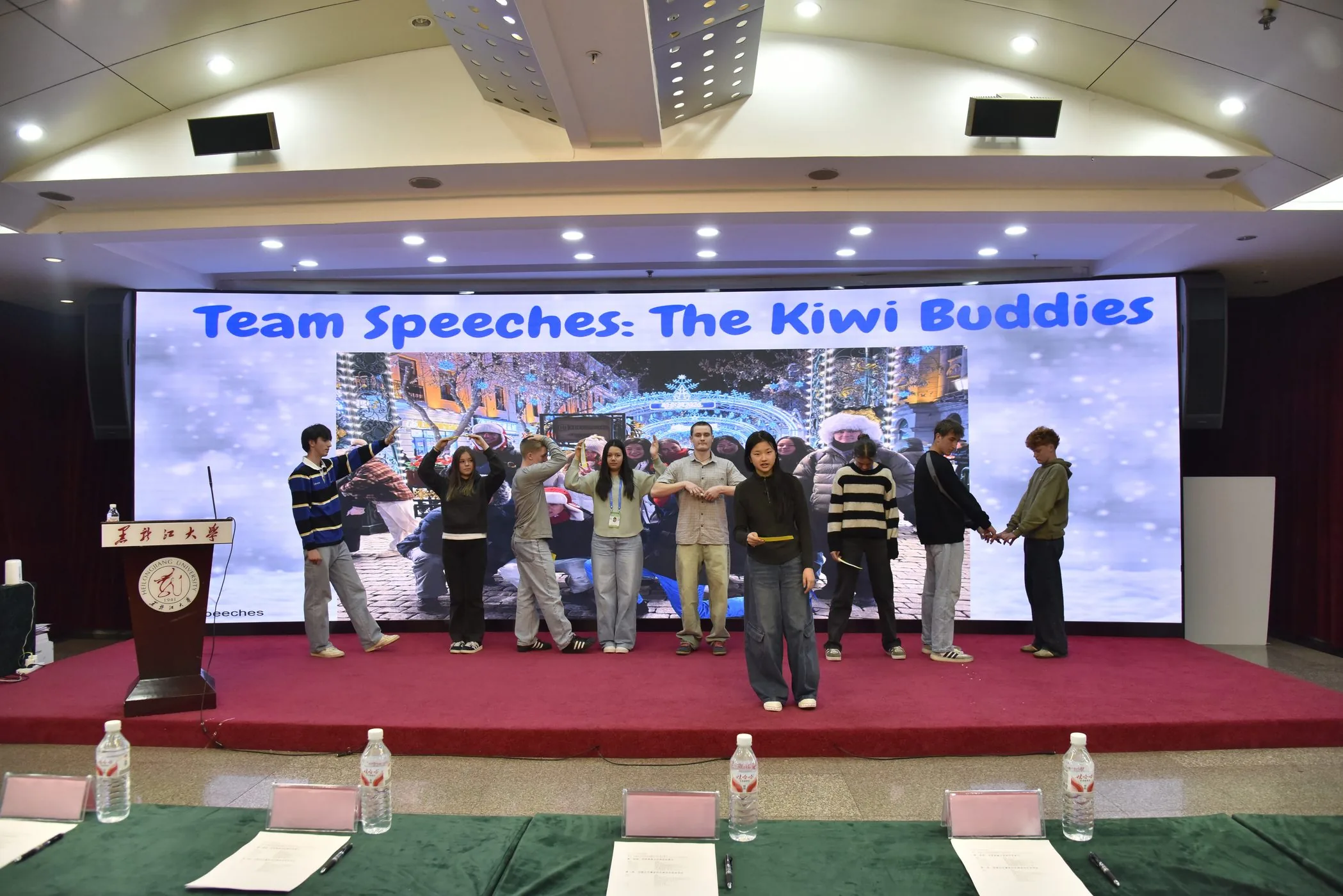 Students presenting team speeches on stage
